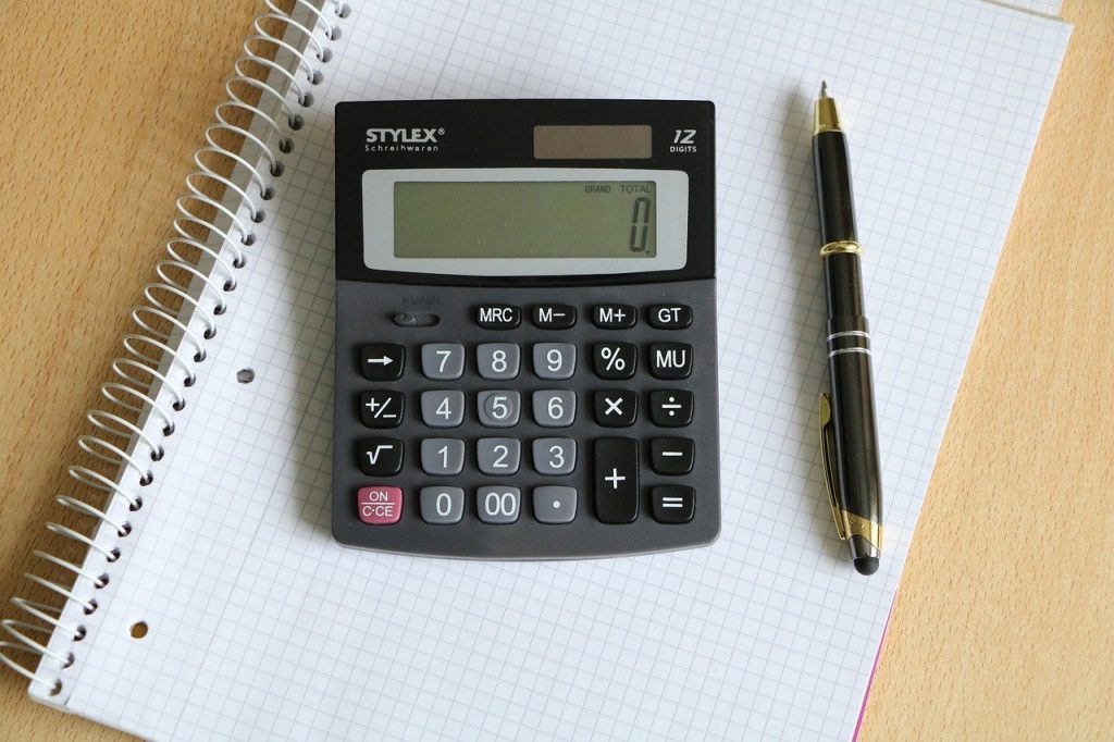 calculator, pen, block